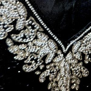 That perfect festive blouse black with silver sequins neckline,arms and waist.
